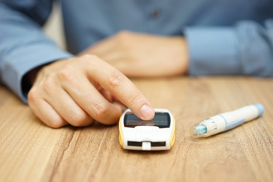 man testing glucose level with a digital glucometer diabetes treatment

** Note: Shallow depth of field