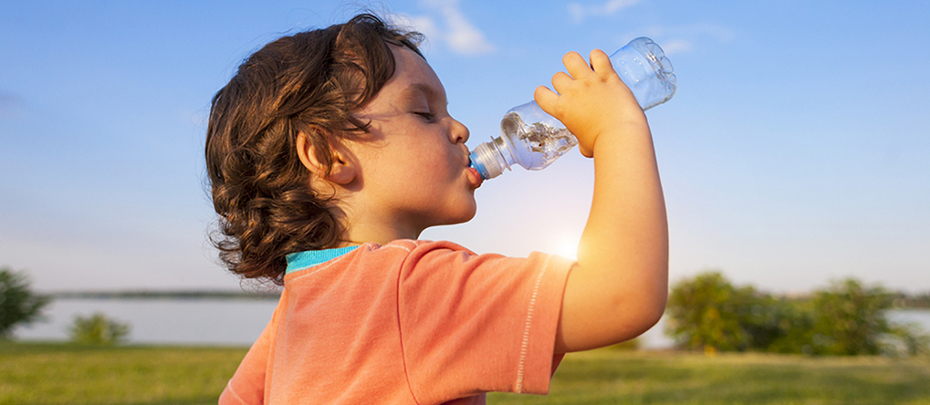 A child drinks water from a bottle while walking, baby health.; Shutterstock ID 692671543; Other: ; Purchase Order: 123; Client/Licensee: ; Job: